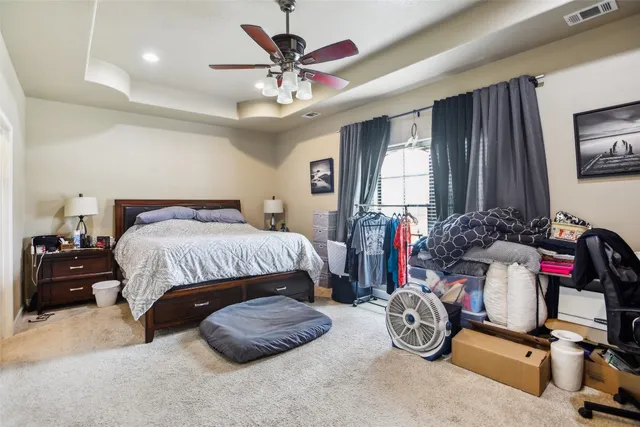a bedroom with bed and a large mirror
