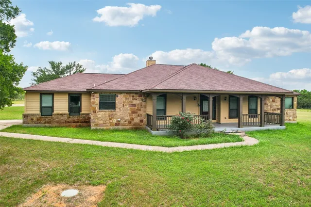 a front view of a house with a garden