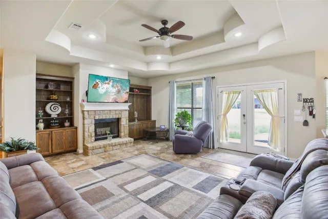 a living room with furniture a flat screen tv and a fireplace