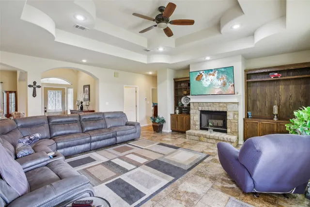 a living room with furniture and a fireplace