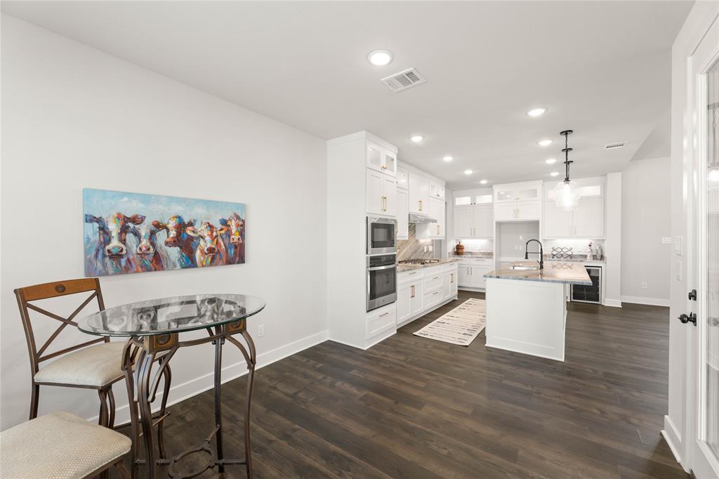 441 Collum View Azle, TX 76020 - Photo 13 of 38 Kitchen with recessed lighting, pendant lighting, a kitchen island with sink, white cabinets, and dark wood-style floors