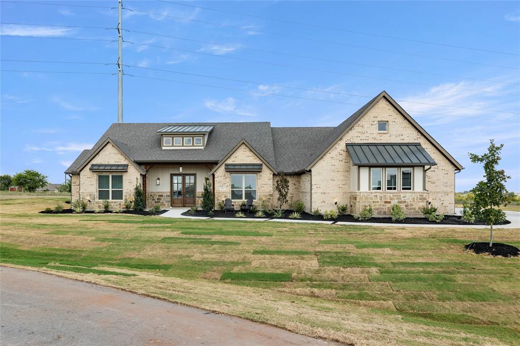 441 Collum View Azle, TX 76020 - Photo 2 of 38 View of front of home featuring stone siding, a front lawn, a standing seam roof, and covered porch