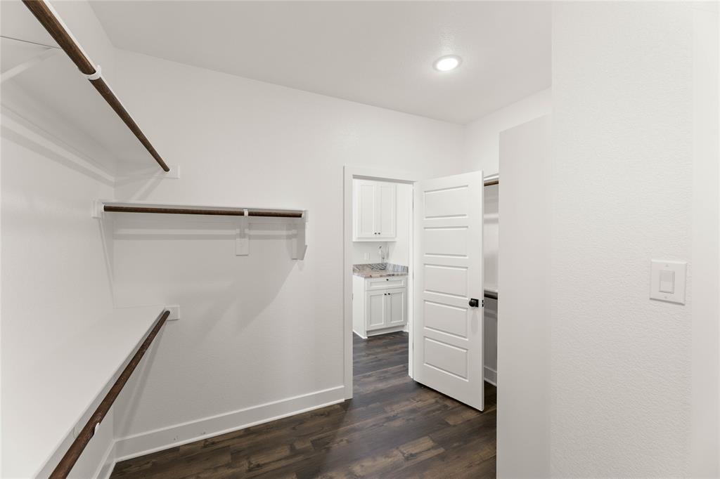 441 Collum View Azle, TX 76020 - Photo 24 of 38 Walk in closet with dark wood-style floors