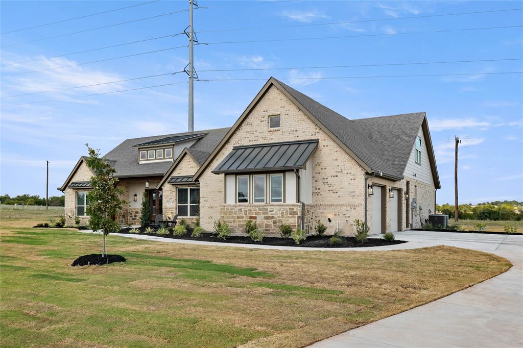 441 Collum View Azle, TX 76020 - Photo 3 of 38 View of front of house featuring a standing seam roof, concrete driveway, brick siding, a garage, and a front lawn