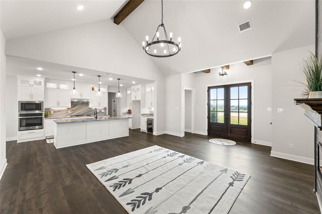 441 Collum View Azle, TX 76020 - Photo 7 of 38 Unfurnished living room with recessed lighting, beam ceiling, high vaulted ceiling, dark wood-style floors, and french doors