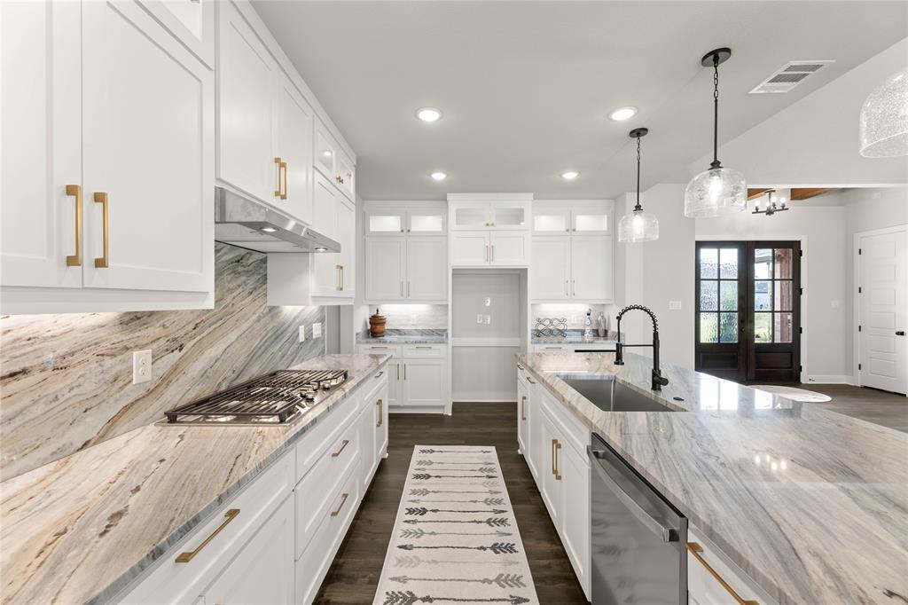 441 Collum View Azle, TX 76020 - Photo 10 of 38 Kitchen featuring glass insert cabinets, decorative backsplash, white cabinets, decorative light fixtures, and light stone countertops