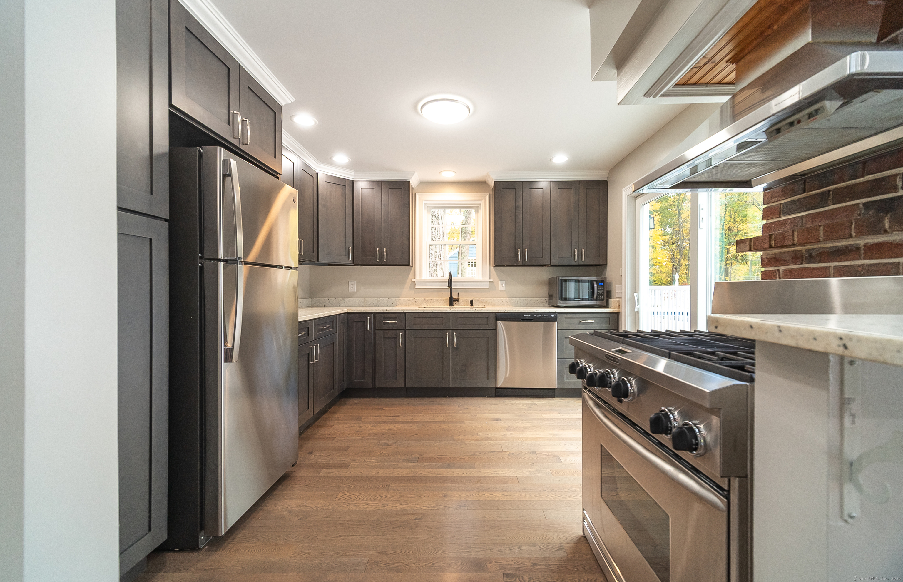 882 Killingworth Road Haddam, CT 06441 - Photo 17 of 40 a kitchen with stainless steel appliances granite countertop a sink a stove a refrigerator and cabinets