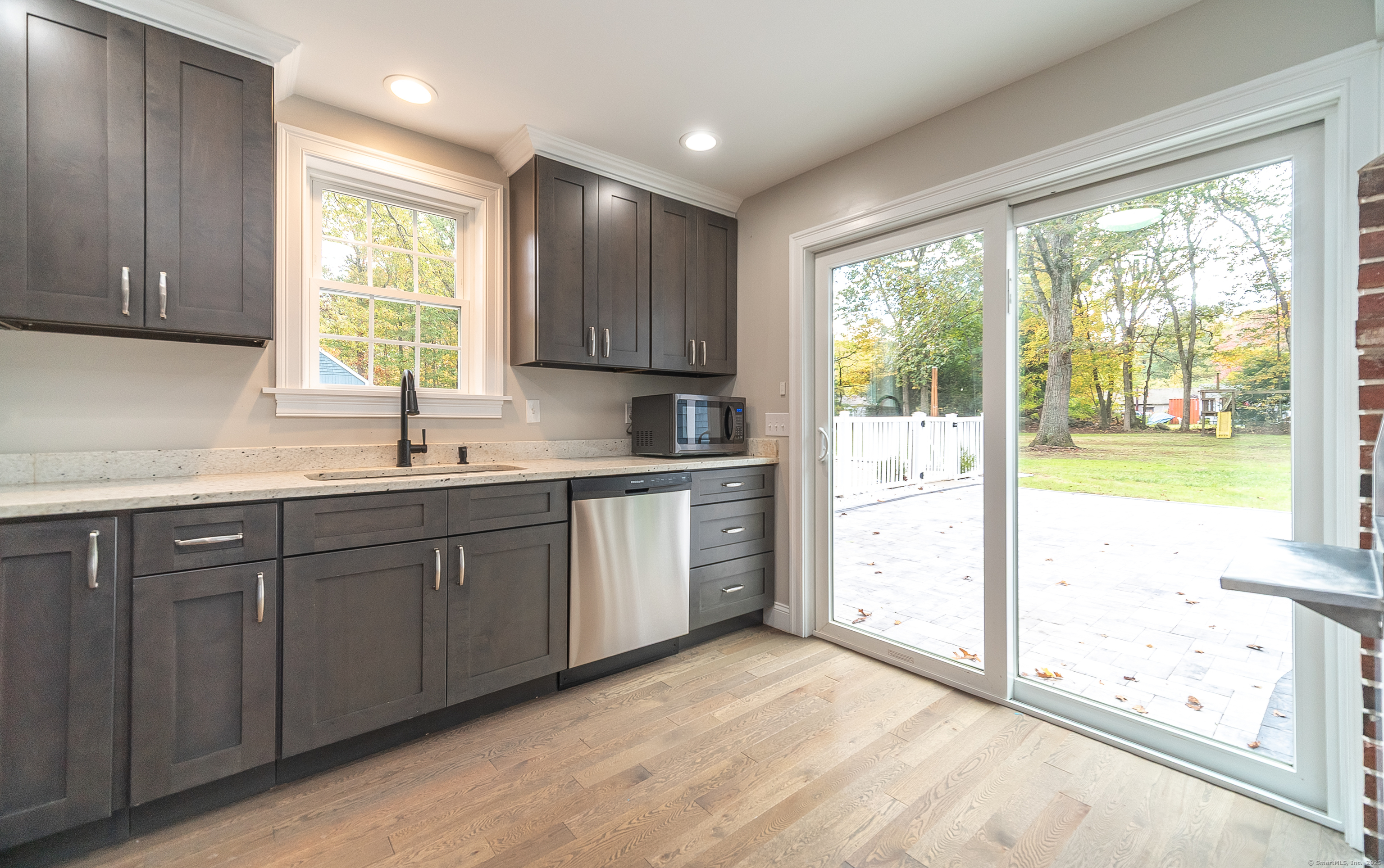 882 Killingworth Road Haddam, CT 06441 - Photo 18 of 40 a kitchen with a sink window and cabinets