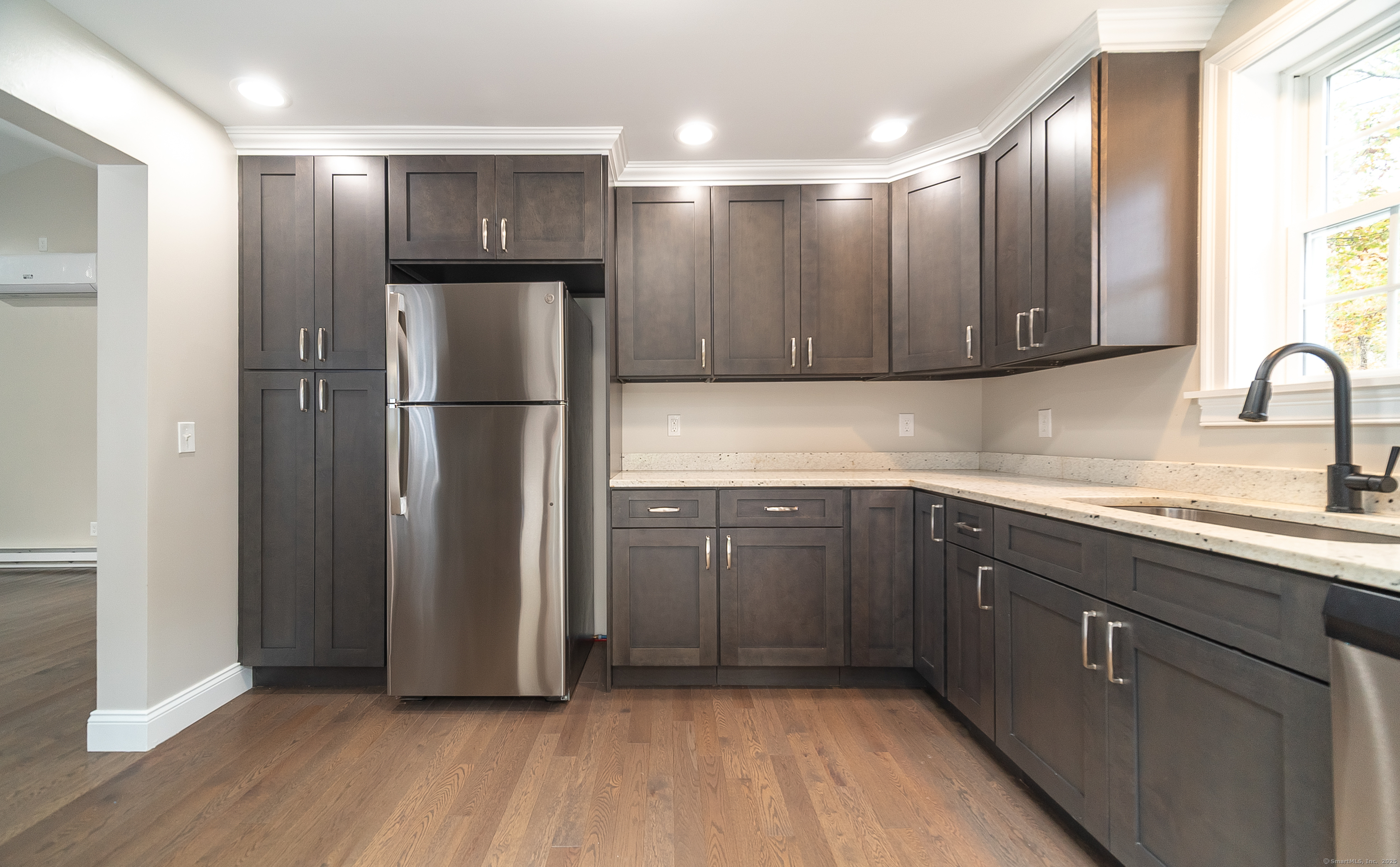 882 Killingworth Road Haddam, CT 06441 - Photo 20 of 40 a kitchen with kitchen island granite countertop wooden cabinets and refrigerator