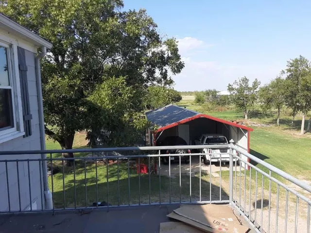 a view of swimming pool with chairs in wooden deck