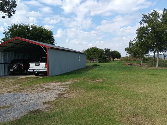 a backyard of a house with lots of green space