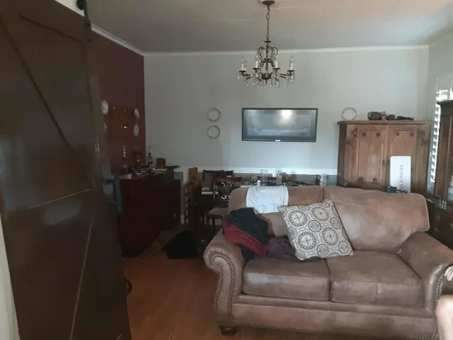 a living room with furniture and a chandelier