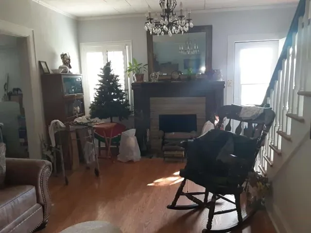 a living room with furniture a table and a fireplace