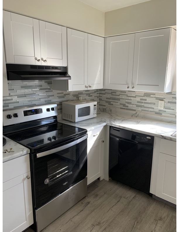 1703 Rockingham Drive Normal, IL 61761 - Photo 6 of 6 a kitchen with granite countertop a stove and a microwave