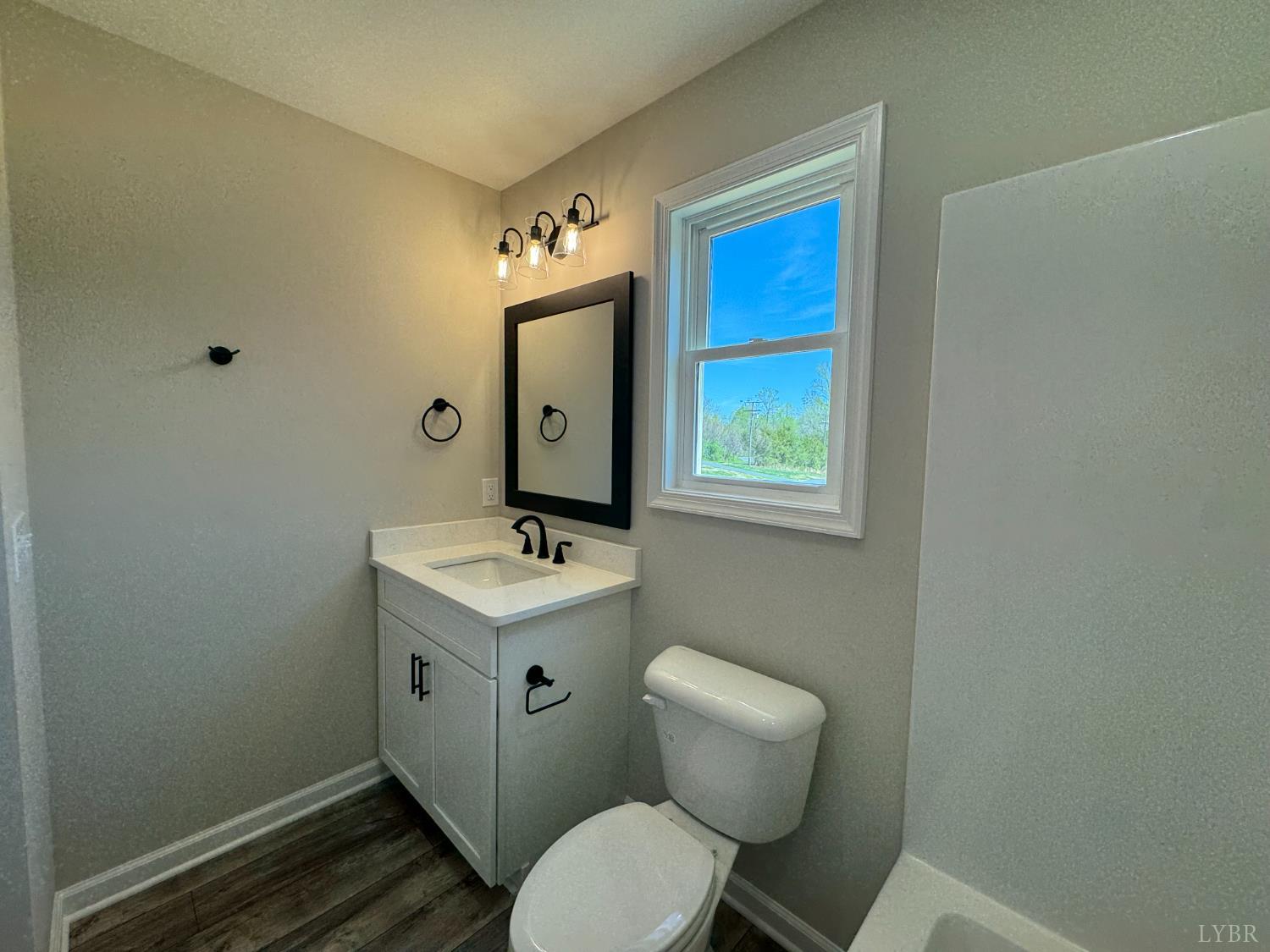 604 Stratford Road Concord, VA 24538 - Photo 13 of 28 a bathroom with a toilet a sink and mirror
