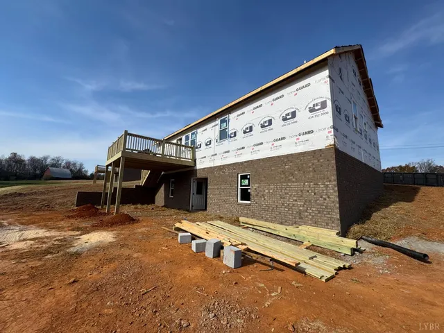 a kitchen with kitchen island granite countertop a sink a counter space appliances and cabinets