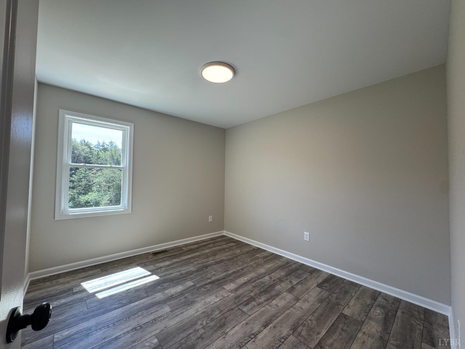 604 Stratford Road Concord, VA 24538 - Photo 9 of 28 an empty room with wooden floor and windows