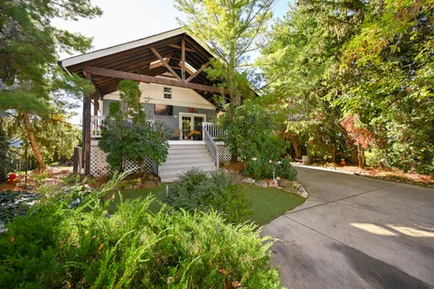 a yellow building with trees in the background