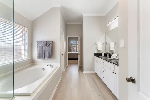 a large white kitchen with a large window