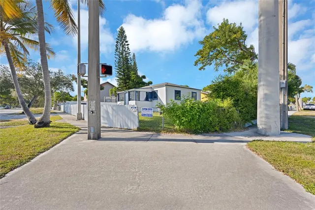 a view of a house with a yard and basketball court