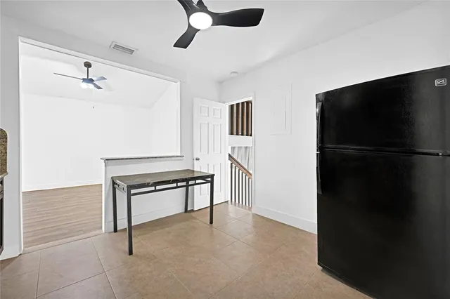 a hallway that has a closet and a chair in it