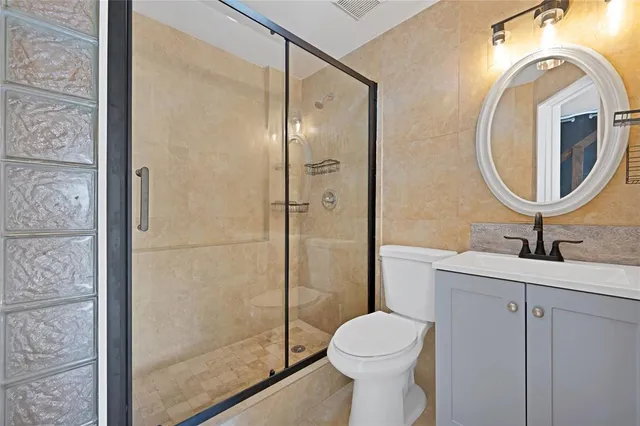 a bathroom with a toilet a sink and a mirror