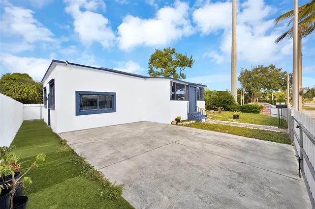 a view of a house with entertaining space and a yard