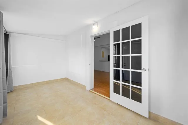 a view of an empty room with empty shelves