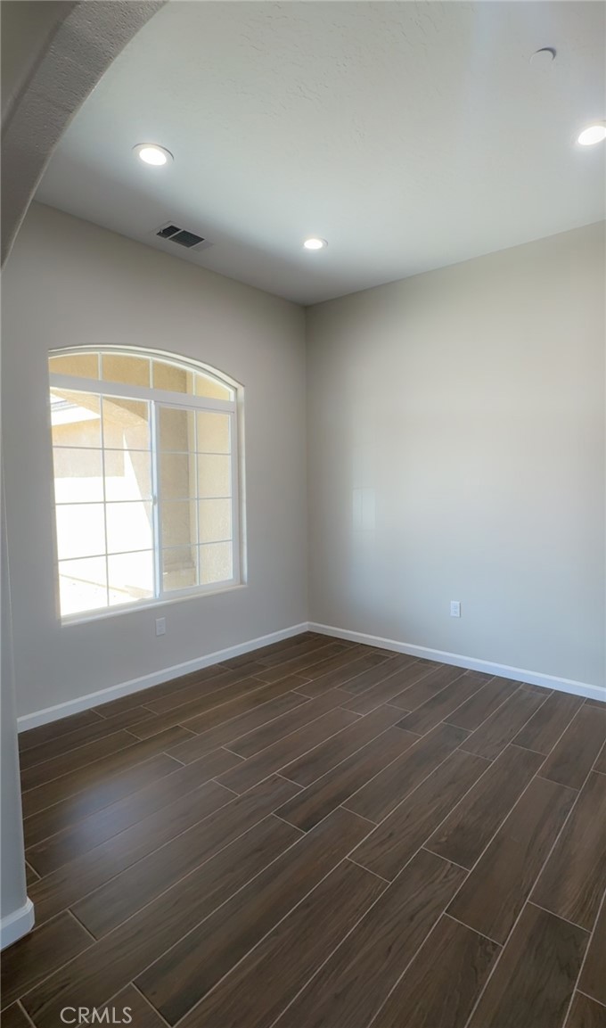 16506 Cactus Street Hesperia, CA 92345 - Photo 17 of 34 an empty room with wooden floor and windows