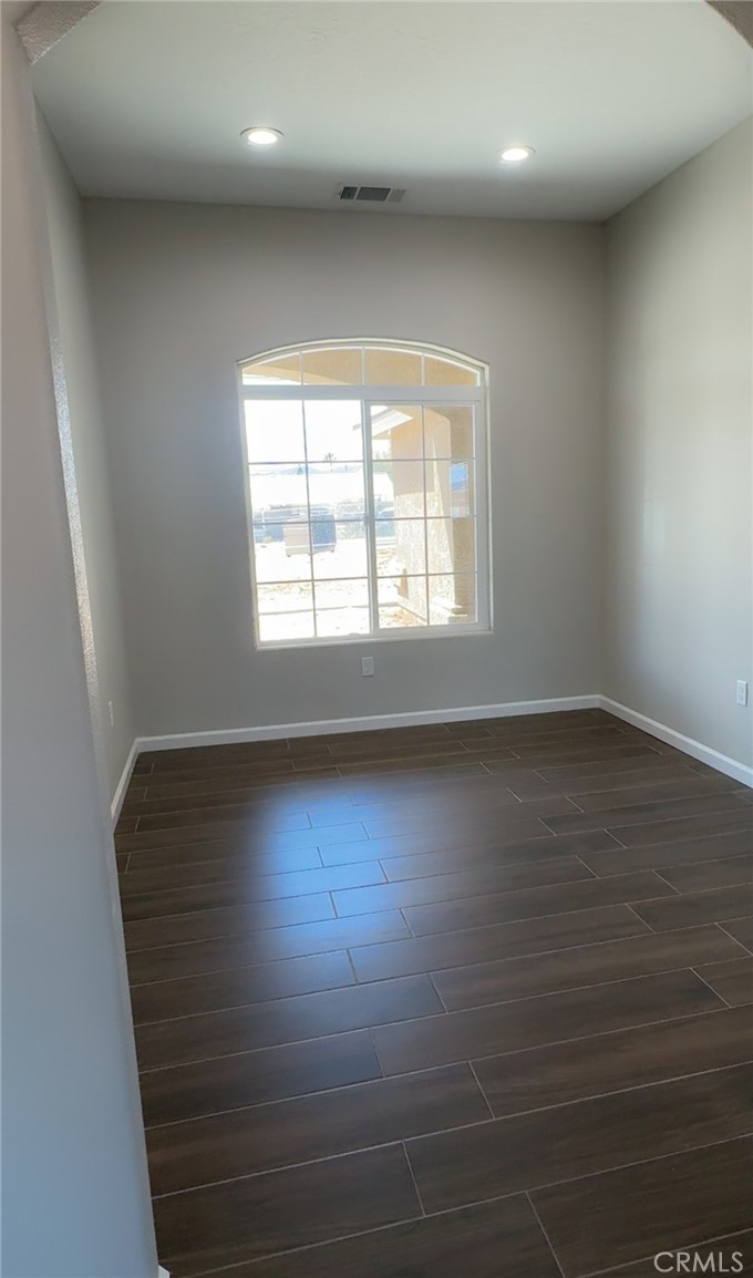 16506 Cactus Street Hesperia, CA 92345 - Photo 18 of 34 an empty room with wooden floor and windows