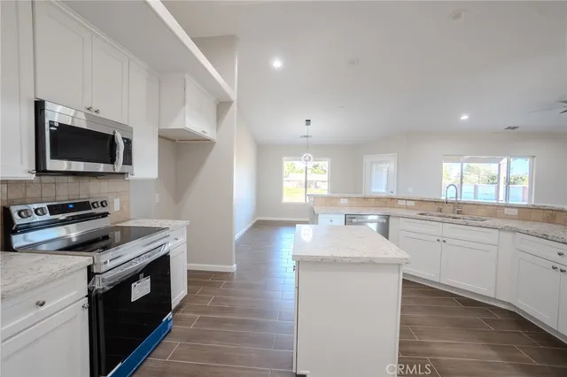 a kitchen with a sink stove and microwave