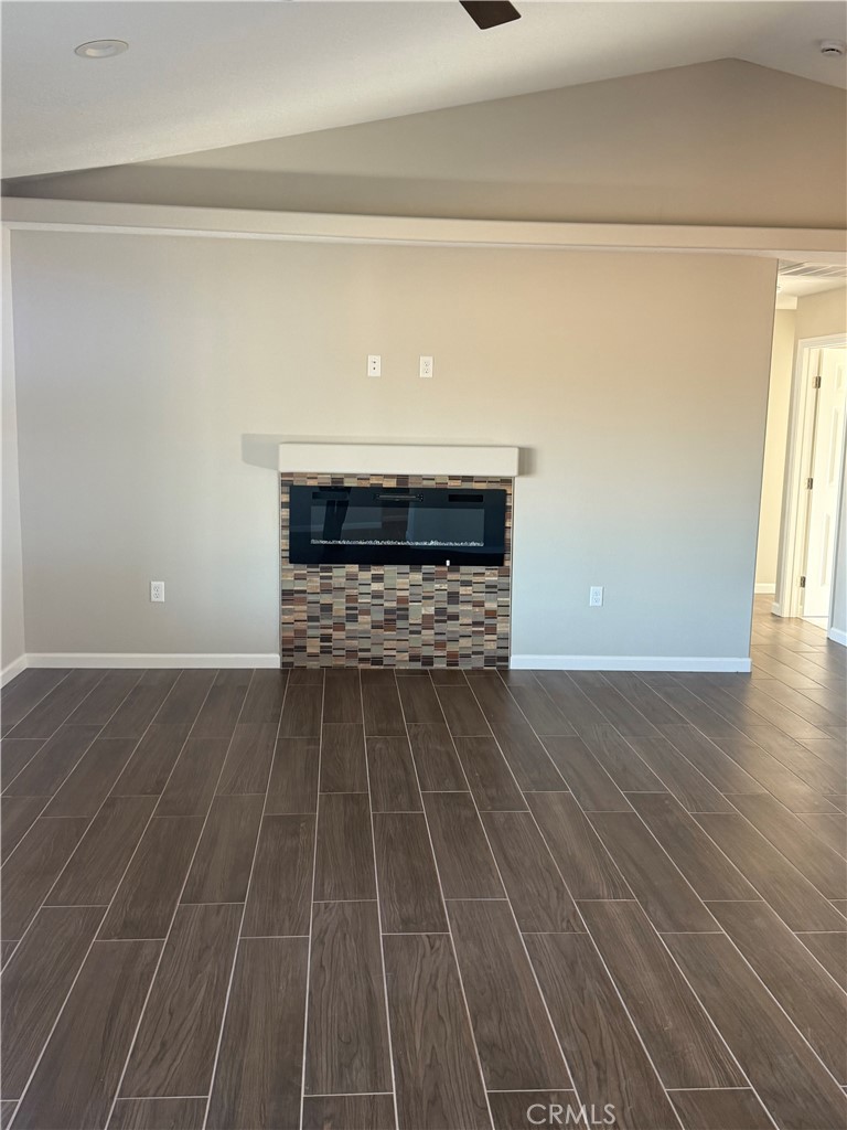 16506 Cactus Street Hesperia, CA 92345 - Photo 3 of 34 a room with a fireplace and wooden floor