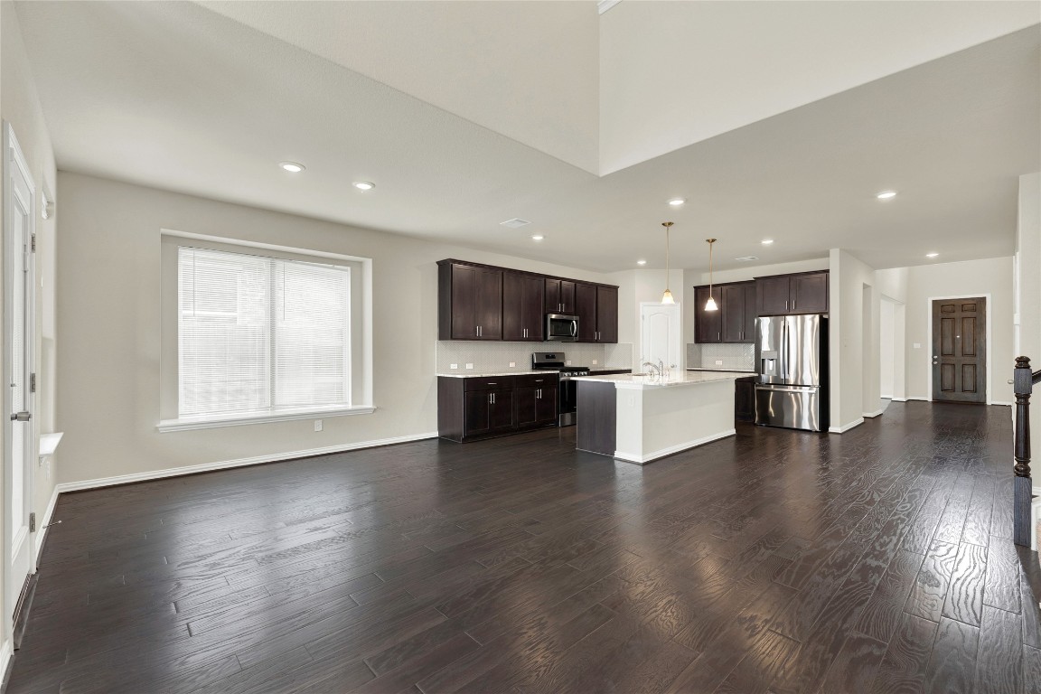 908 Leadtree Loop Buda, TX 78610 - Photo 15 of 38 a view of kitchen with microwave and refrigerator
