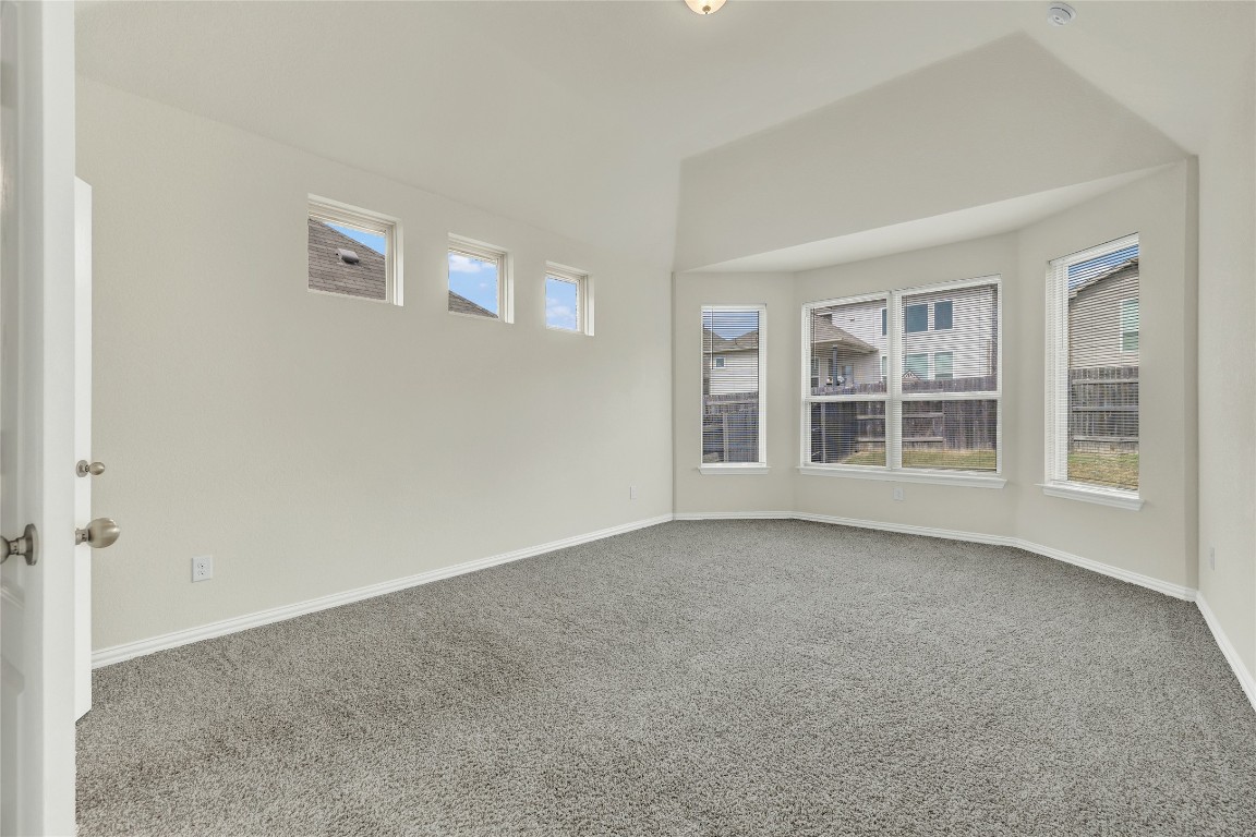 908 Leadtree Loop Buda, TX 78610 - Photo 18 of 38 a view of empty room with windows