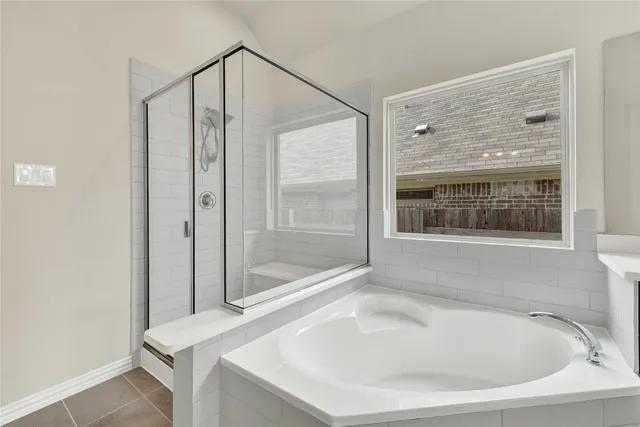 a spacious bathroom with a tub shower and sink