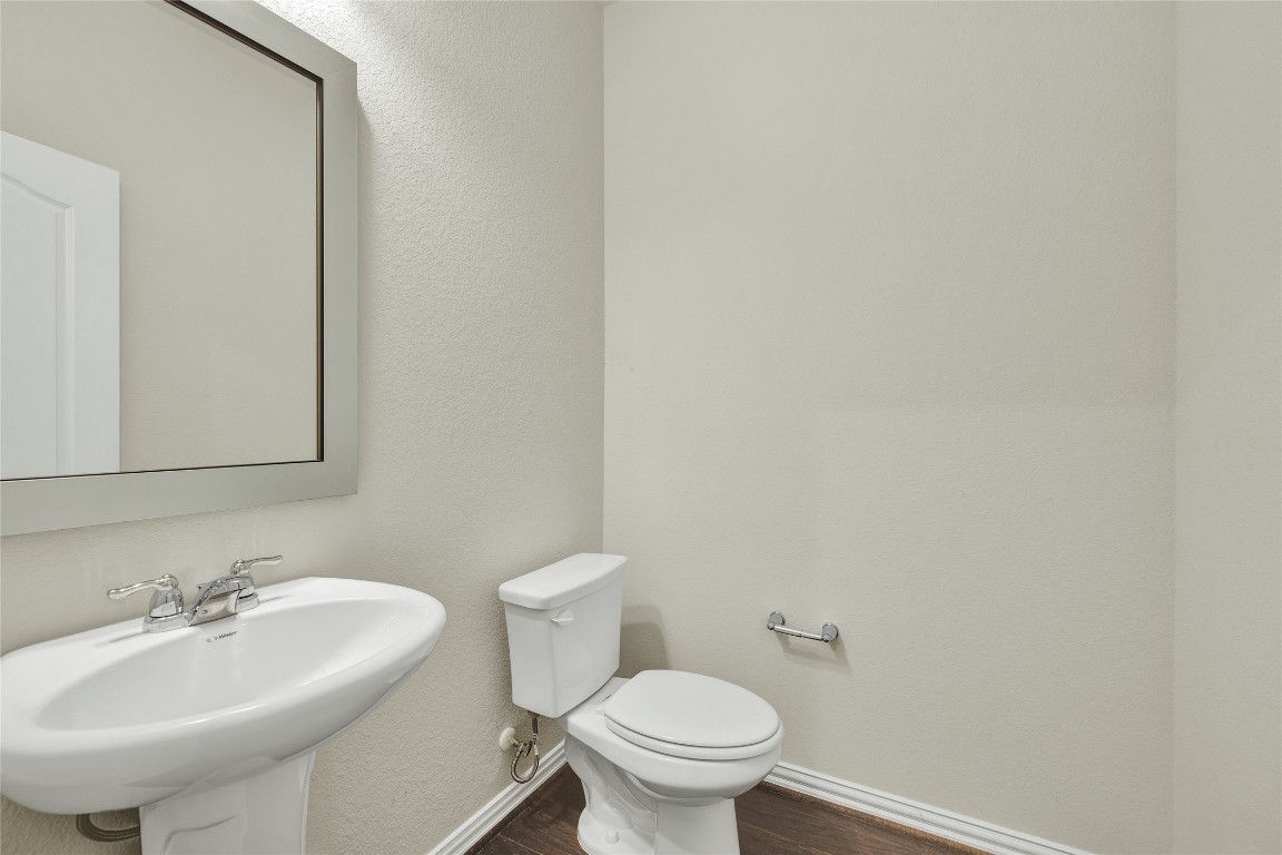 908 Leadtree Loop Buda, TX 78610 - Photo 26 of 38 a bathroom with a sink a toilet and mirror