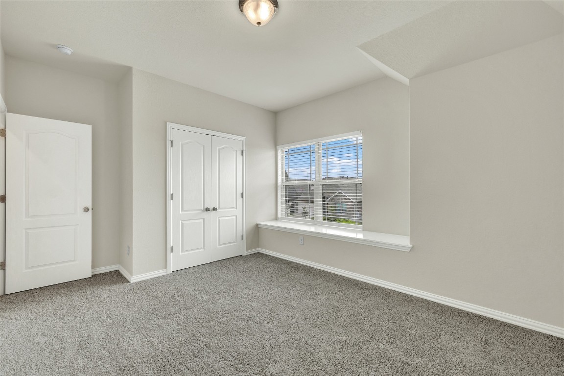 908 Leadtree Loop Buda, TX 78610 - Photo 31 of 38 an empty room with windows