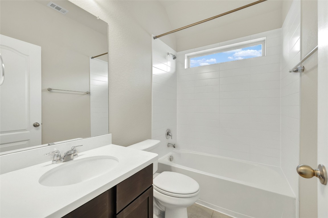 908 Leadtree Loop Buda, TX 78610 - Photo 32 of 38 a bathroom with a sink a toilet and shower