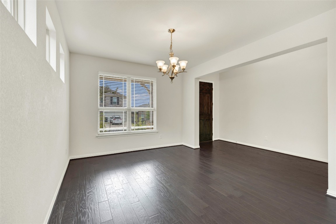 908 Leadtree Loop Buda, TX 78610 - Photo 4 of 38 a view of an empty room with wooden floor and a window