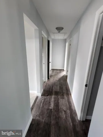 a bathroom with a granite countertop toilet sink and mirror
