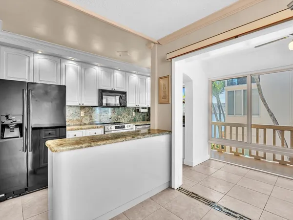 a kitchen with counter top space and refrigerator