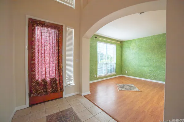 a view of an empty room with glass door