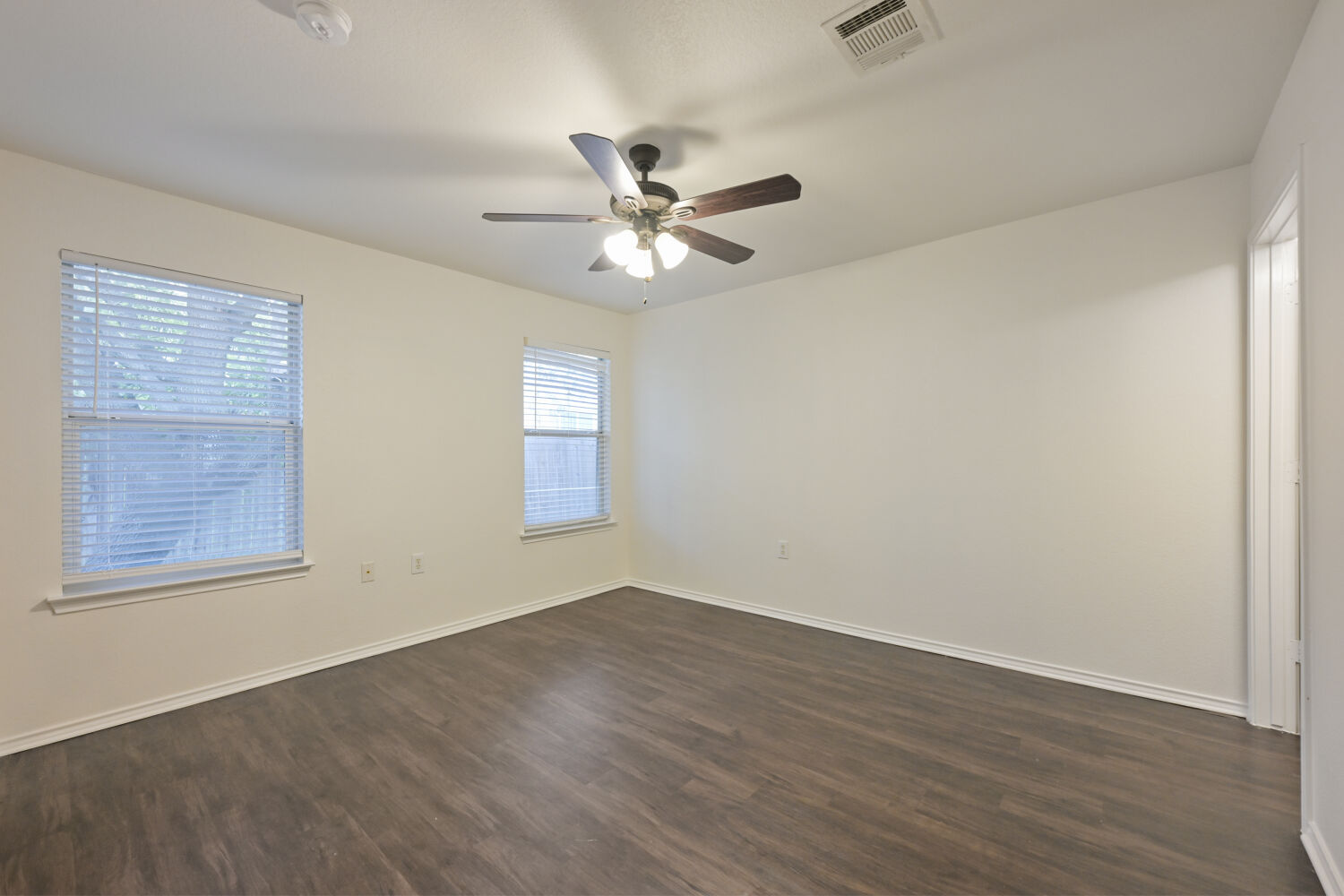 6733 Doyal Drive Austin, TX 78747 - Photo 10 of 28 Laminate flooring and window blinds complement this spacious, ready-to-personalize interior.