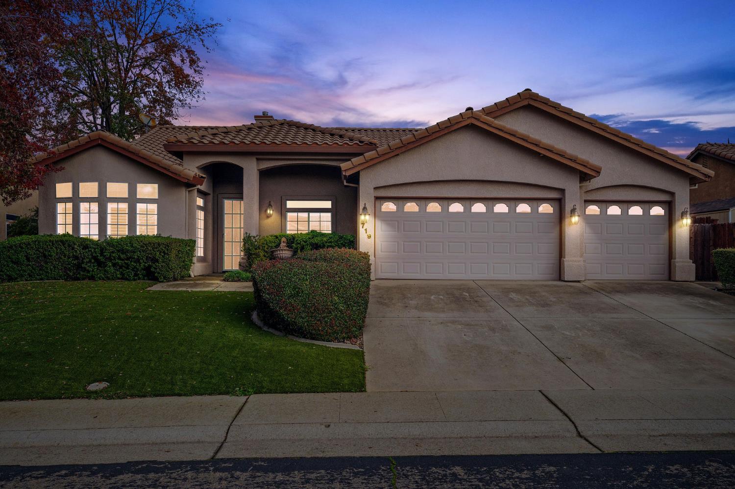 a view of a house with a garden and yard