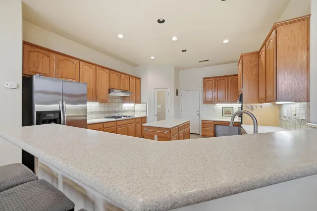 a kitchen with stainless steel appliances granite countertop a sink and cabinets
