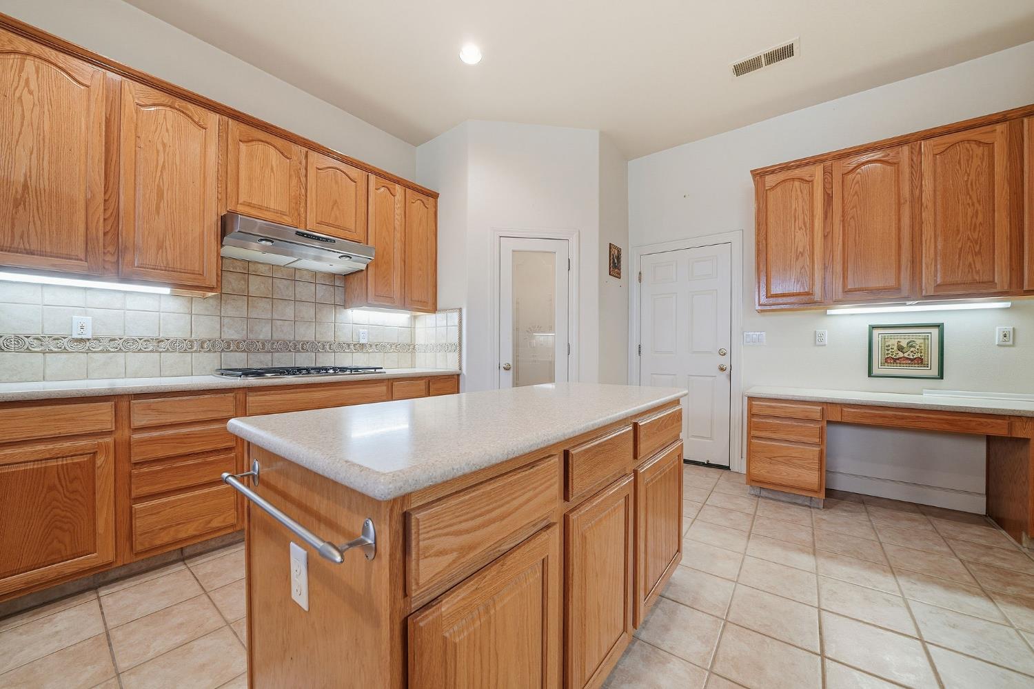 719 Shakeley Lane Ione, CA 95640 - Photo 15 of 68 a kitchen with stainless steel appliances granite countertop a sink and dishwasher a stove with wooden cabinets
