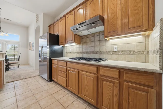 a living room with furniture and a kitchen view