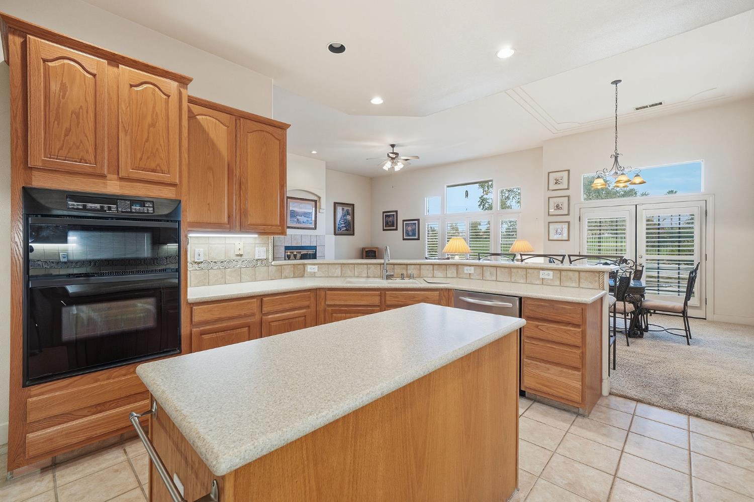 719 Shakeley Lane Ione, CA 95640 - Photo 21 of 68 a kitchen with stainless steel appliances granite countertop a stove a sink and a microwave