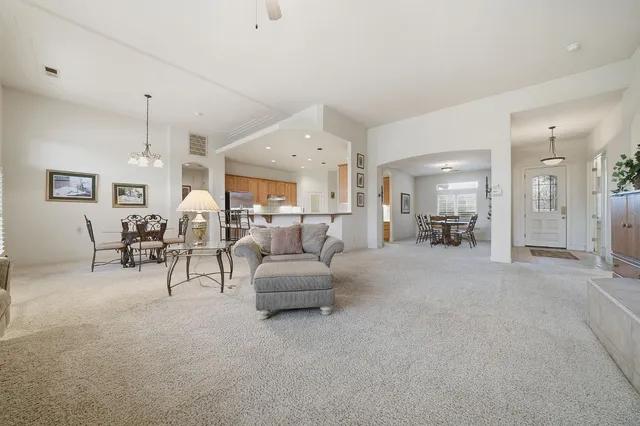 a bedroom with a bed and a lamp on dresser