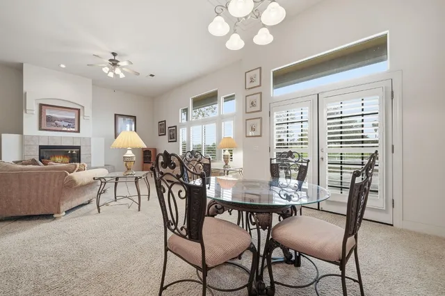 an empty room with windows and ceiling fan